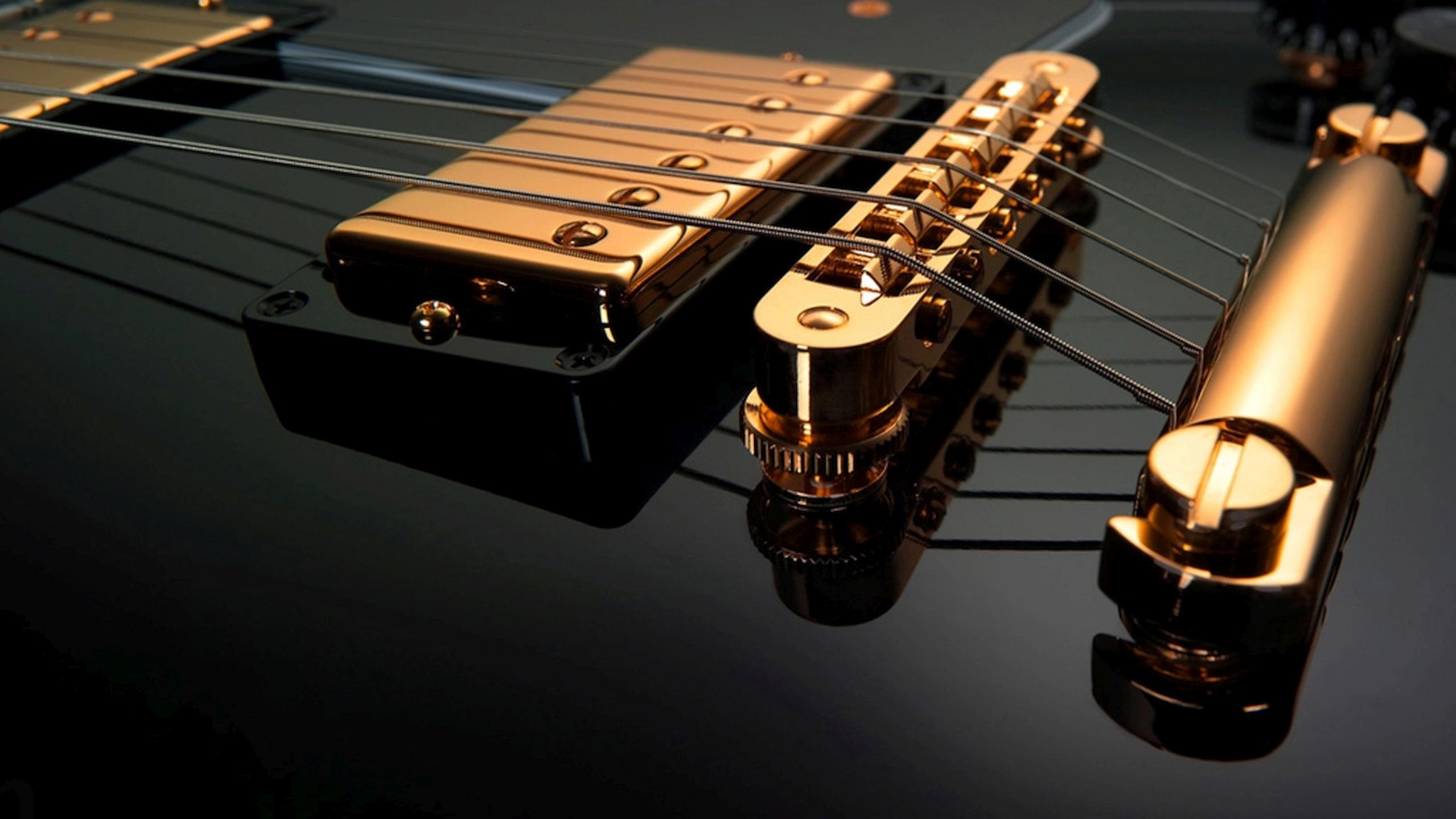 Black-Gold-Guitar-ipad-wallpaper-ilikewallpaper_com.jpg